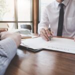 Business Signing a Contract Buy - sell house, Man sign a home insurance policy on home loans, insurance agent analyzing about home investment loan Real Estate concept