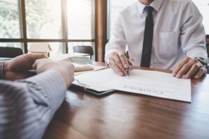 Business Signing a Contract Buy - sell house, Man sign a home insurance policy on home loans, insurance agent analyzing about home investment loan Real Estate concept